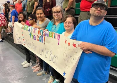 A team of individuals holds a sign "Thanks for answering the calls"