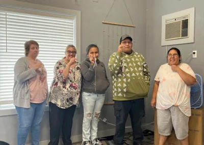 A group of individuals gathered in a room showing their art